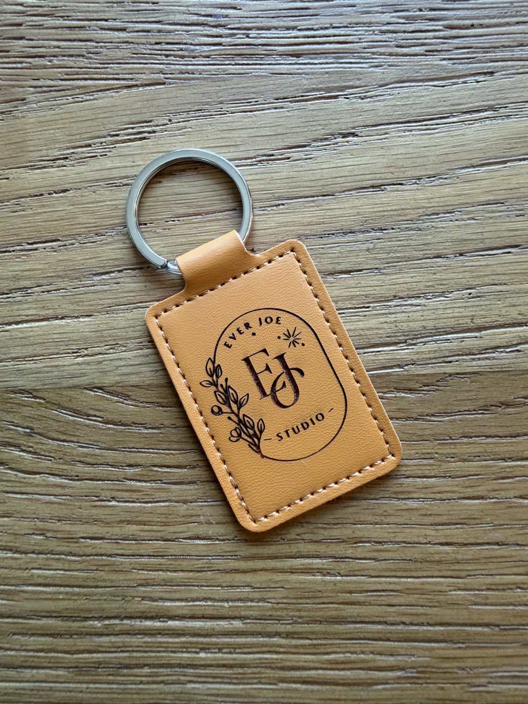 Tan full-grain leather keychain hand-engraved with the Ever Joe Studio badge